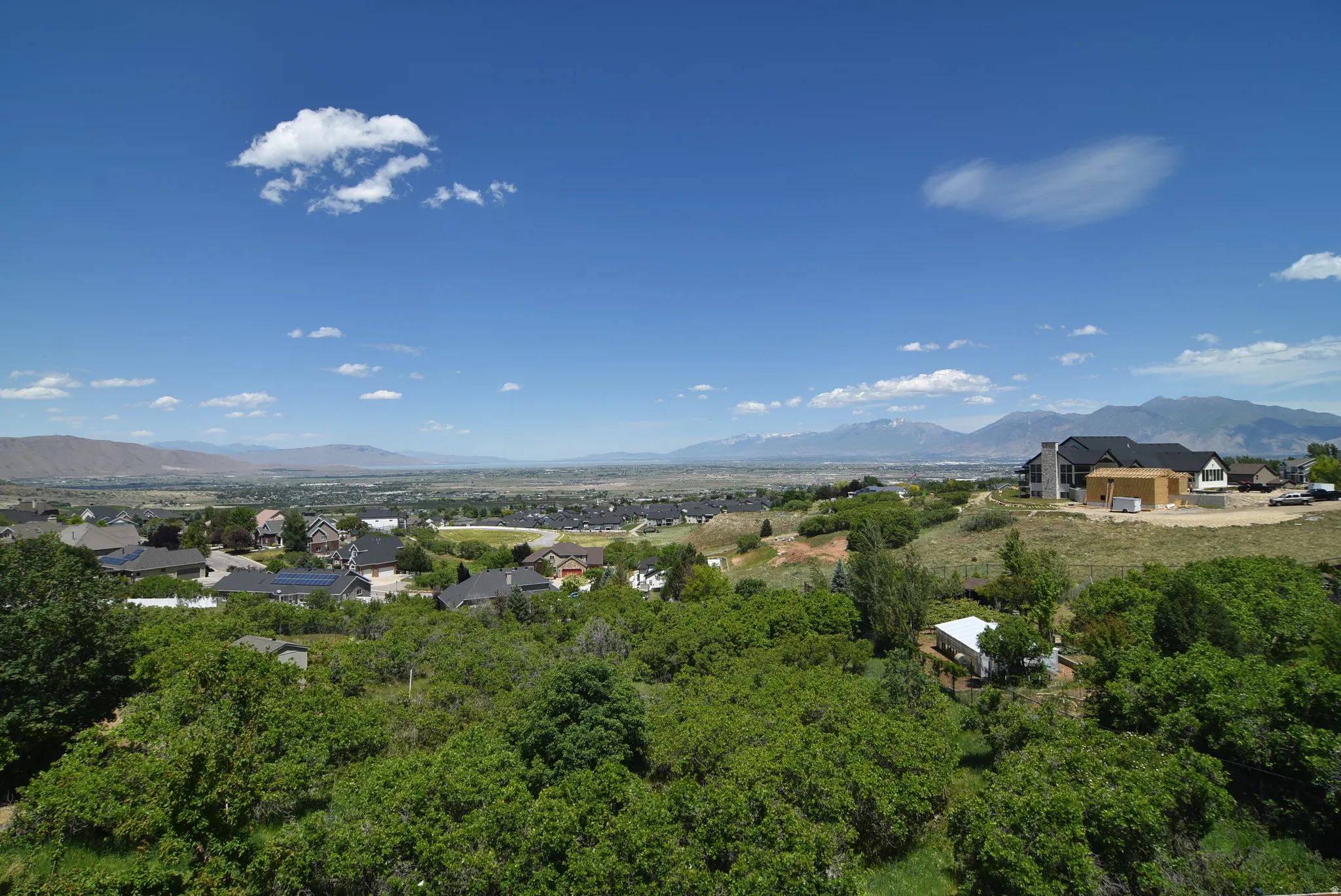 View from Dining area and Living Room. Expansive landscape featuring a distant mountain range and a residential area with varied home styles