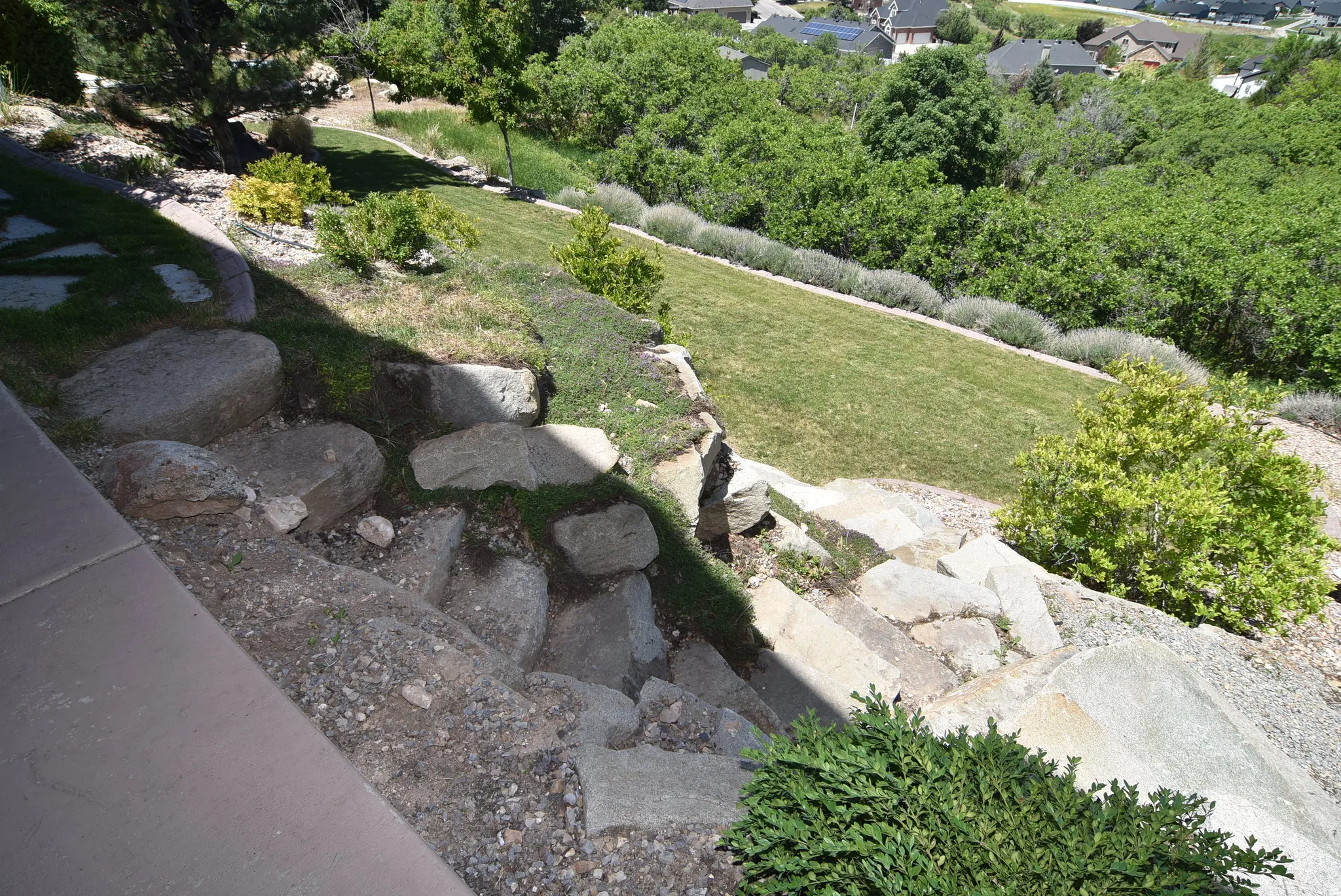 Terraced landscaping featuring natural stone steps and retaining elements