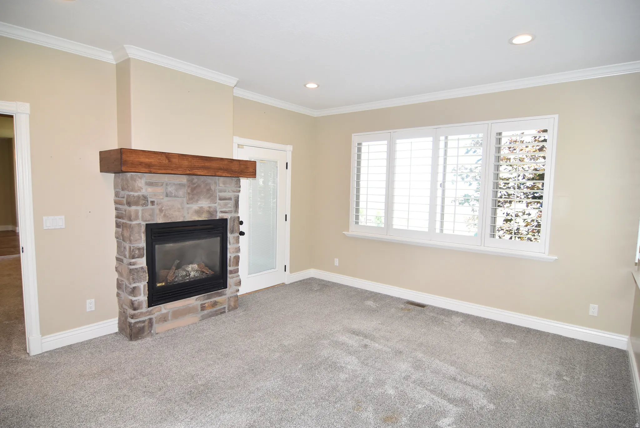 Owner's Bedroom featuring a stone-clad fireplace with a wood mantel