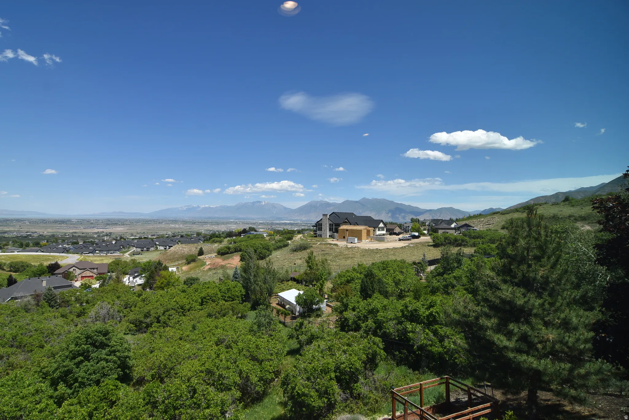 Expansive mountain and valley scenery featuring rolling hills and distant ranges