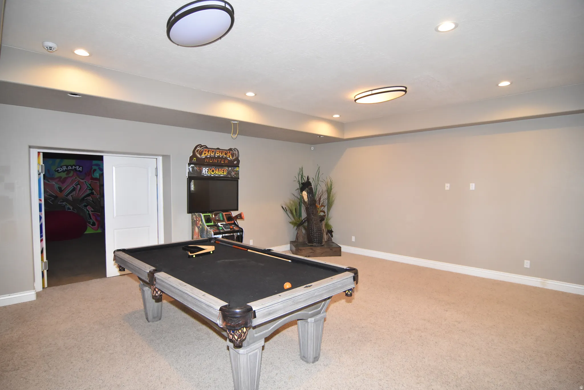 Spacious recreation room featuring recessed lighting and neutral wall tones