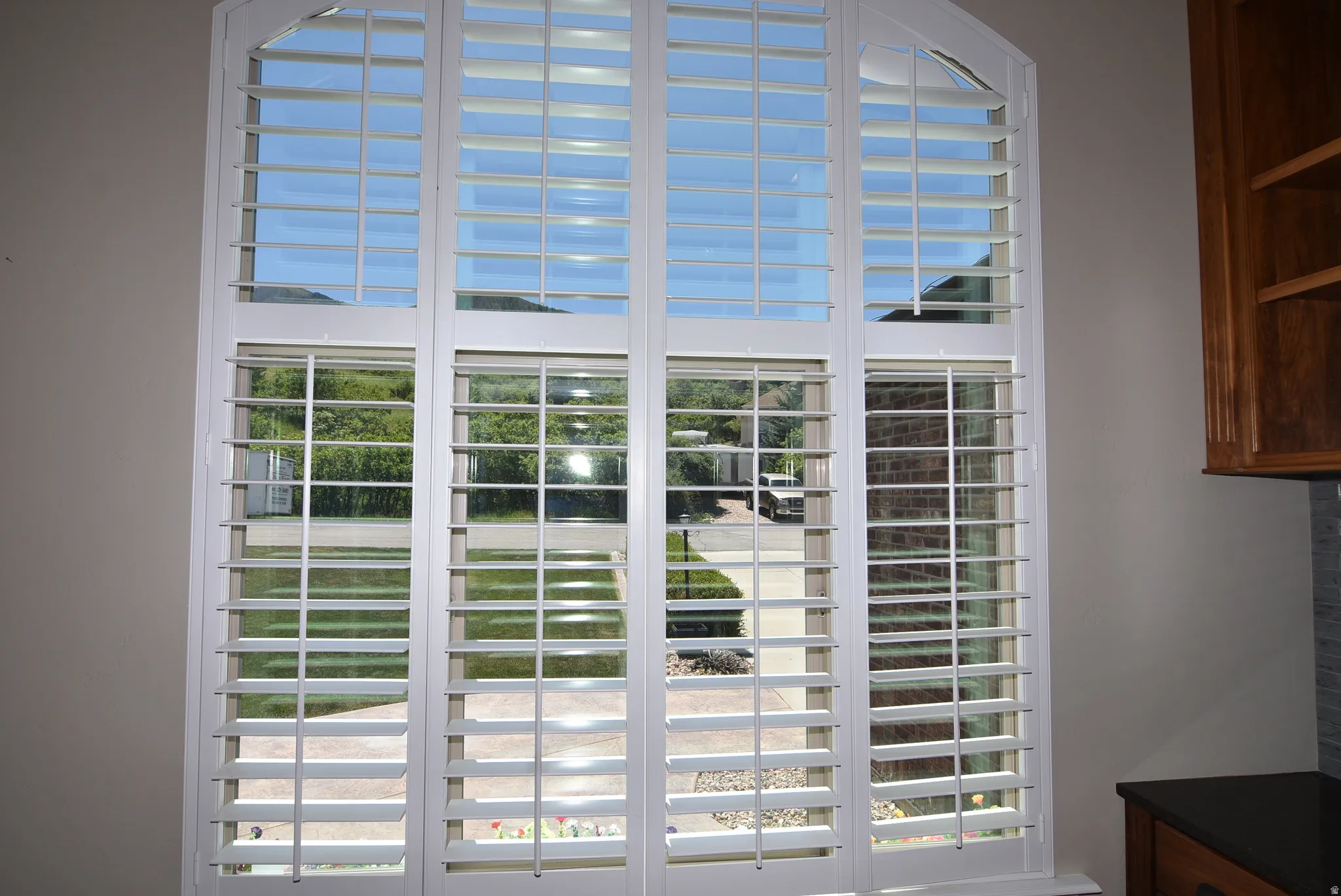 View from Large windows with white plantation shutters