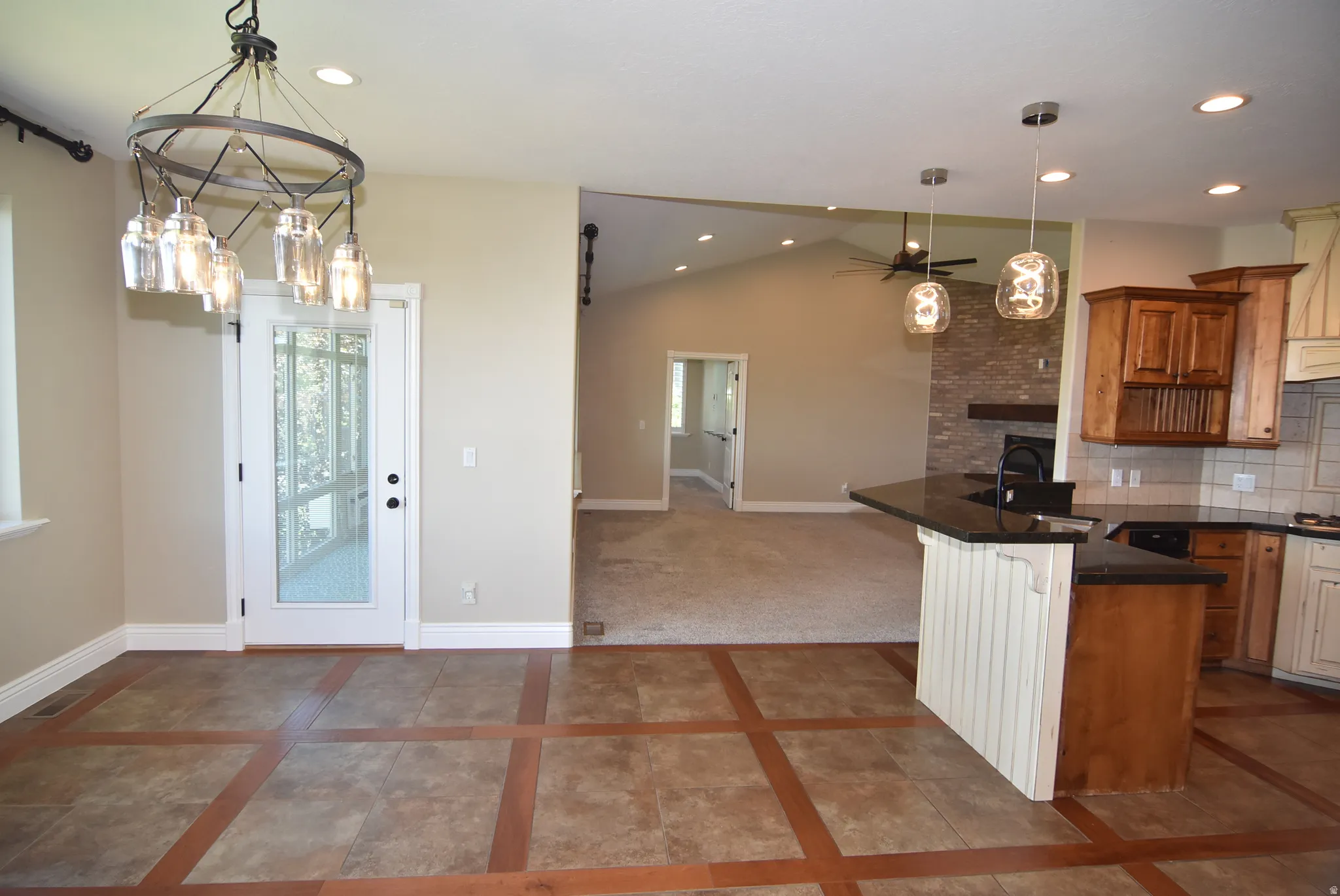 Open-concept living space featuring a dining area adjacent to kitchen and great room with unobstructed views from the dining room window