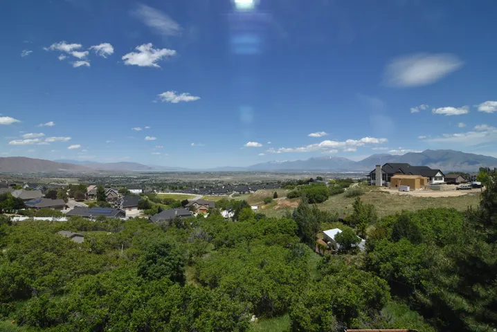 Expansive regional landscape featuring distant mountains and a valley below