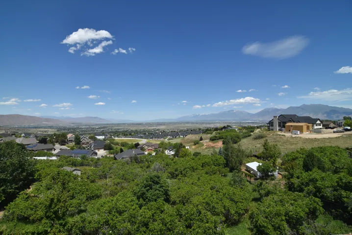 View from Dining area and Living Room. Expansive landscape featuring a distant mountain range and a residential area with varied home styles
