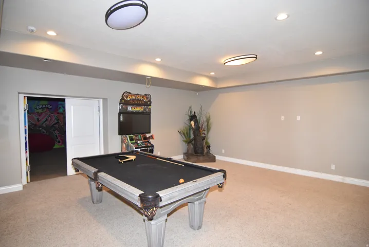 Spacious recreation room featuring recessed lighting and neutral wall tones