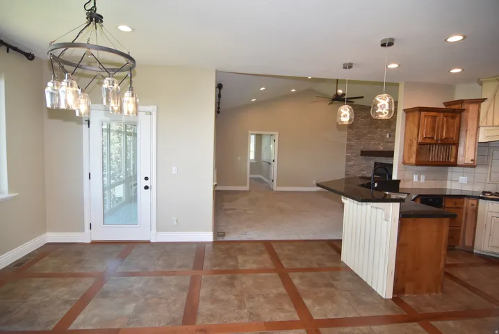 Open-concept living space featuring a dining area adjacent to kitchen and great room with unobstructed views from the dining room window