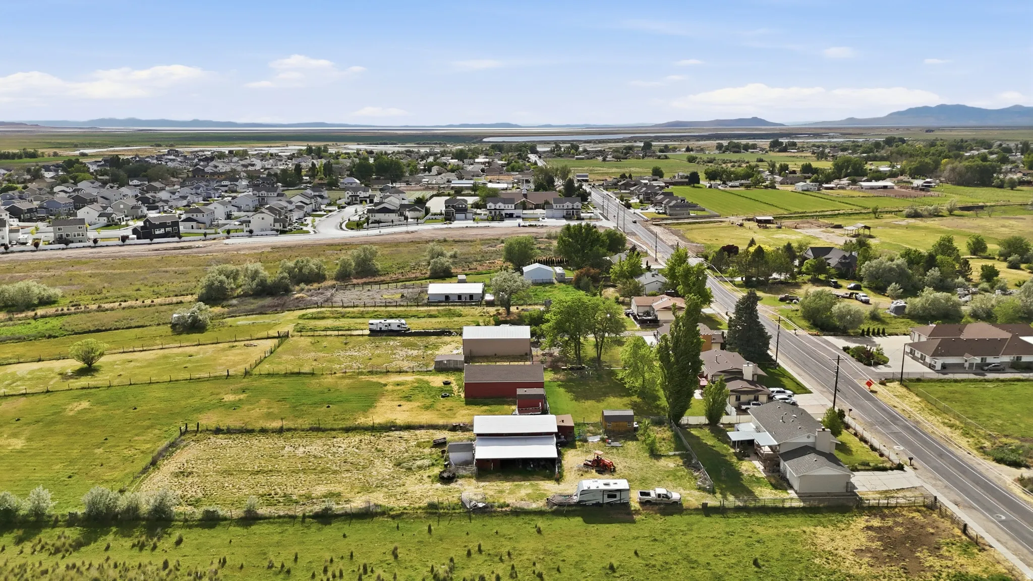 Expansive agricultural land featuring a barn and additional outbuildings