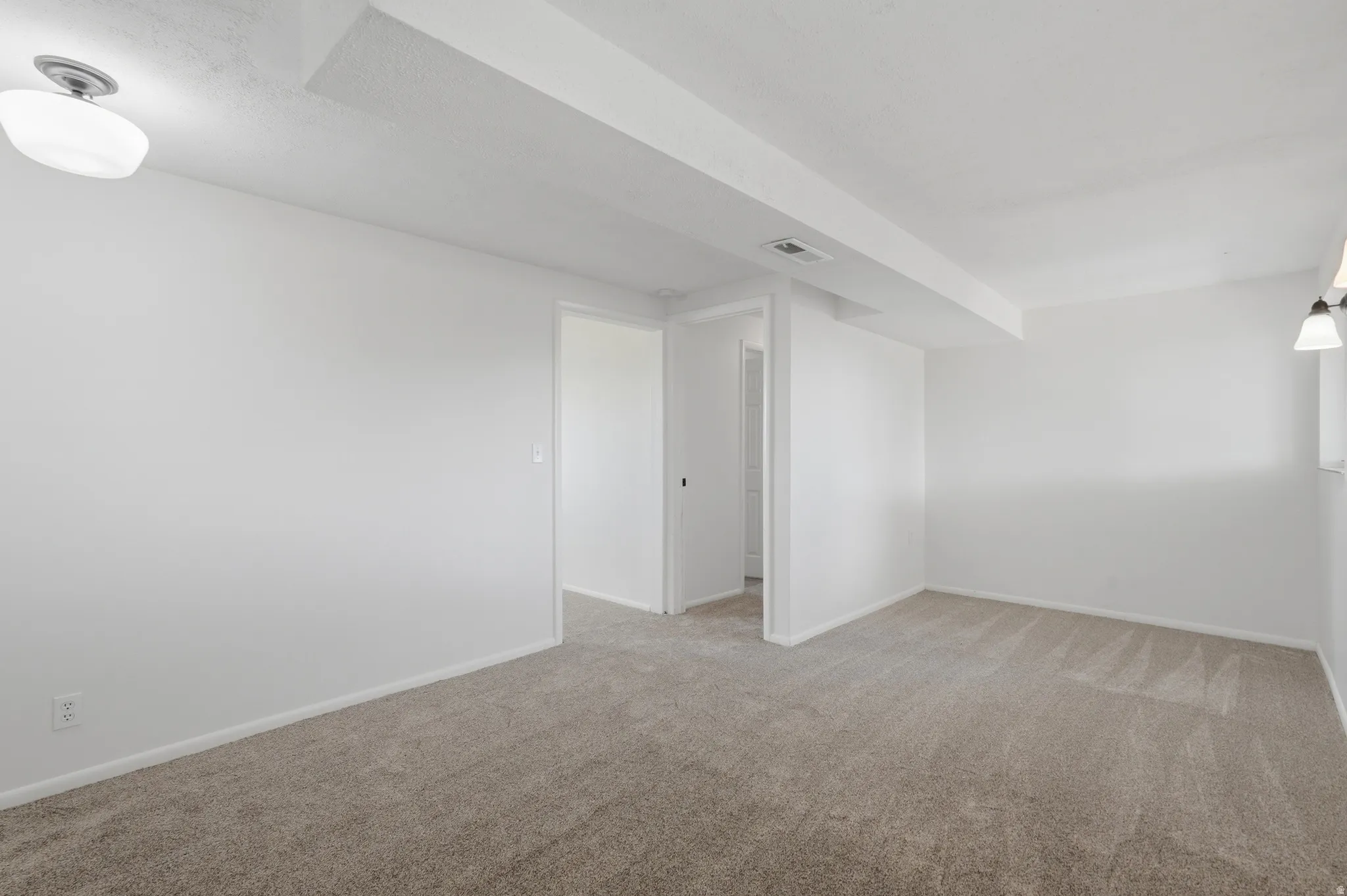 Neutral-toned wall-to-wall carpeting throughout this room