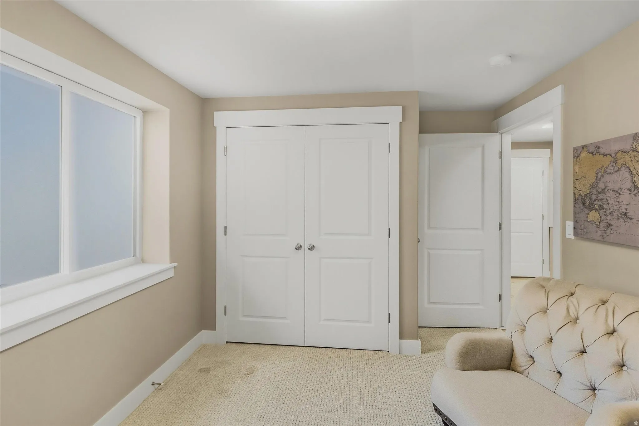 Apartment - Interior room with neutral-toned walls, white trim, and a textured carpet