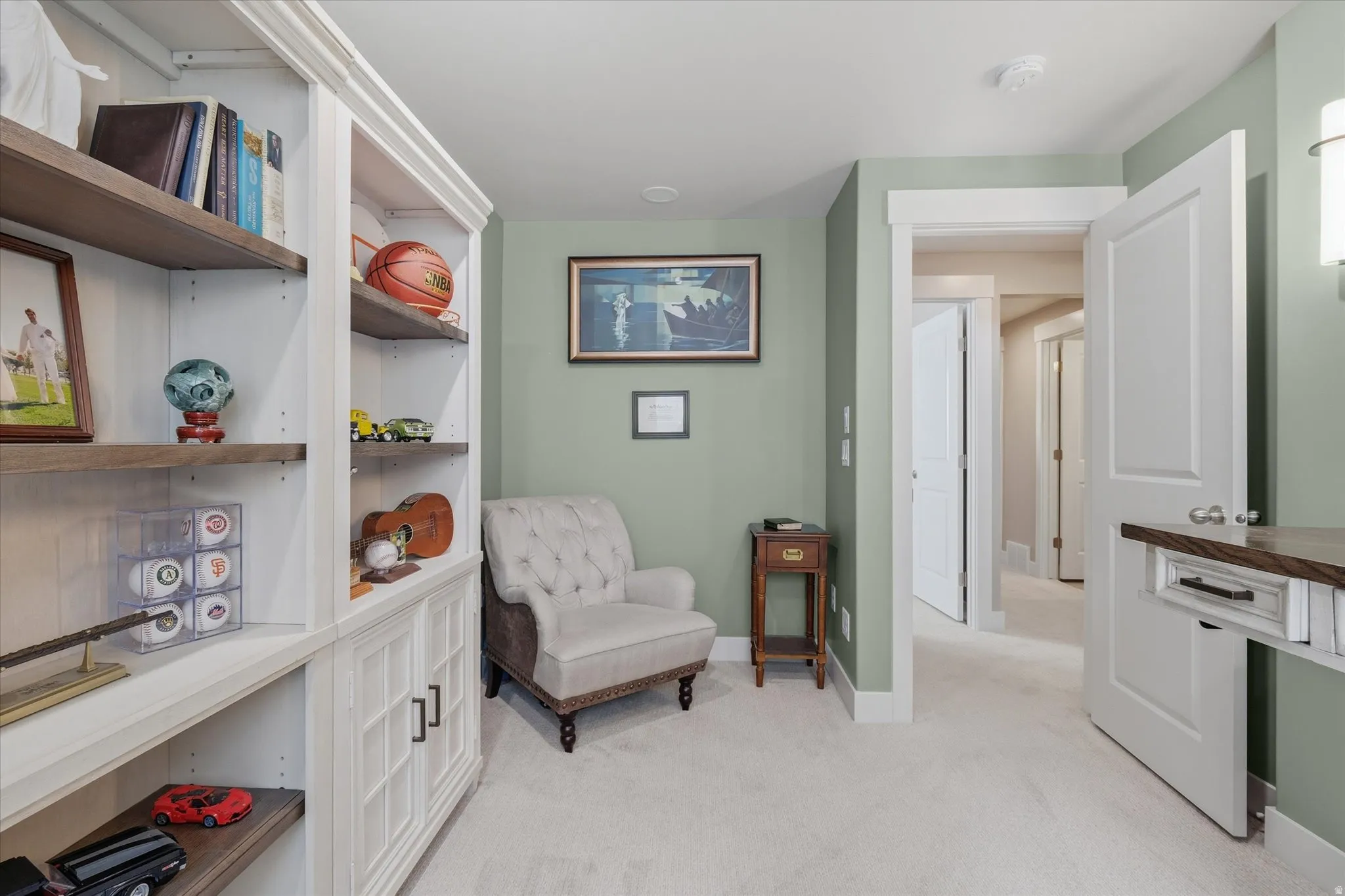 Built-in shelving unit with white cabinetry and wood-finish open shelving