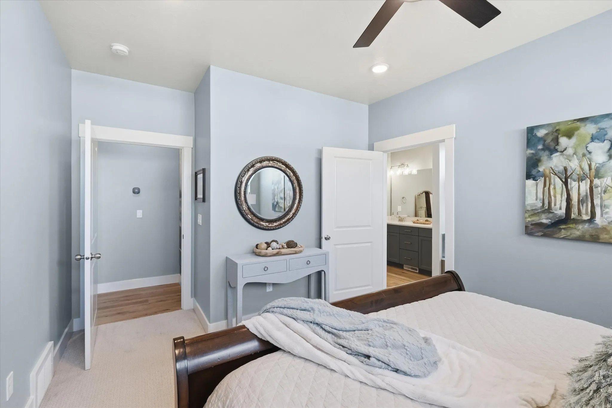 Carpeted room with a ceiling fan and recessed lighting