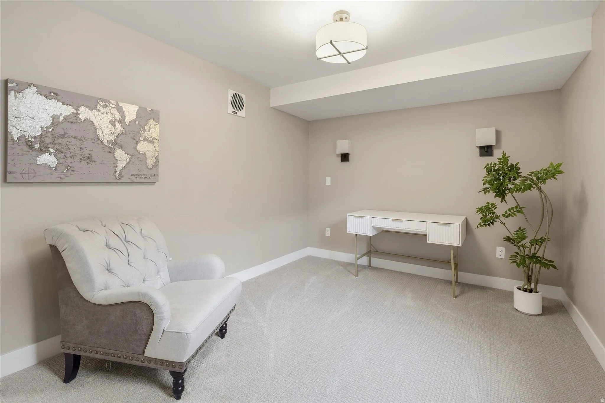 Apartment -Carpeted room featuring neutral-toned walls, white baseboards, and a contemporary ceiling light fixture