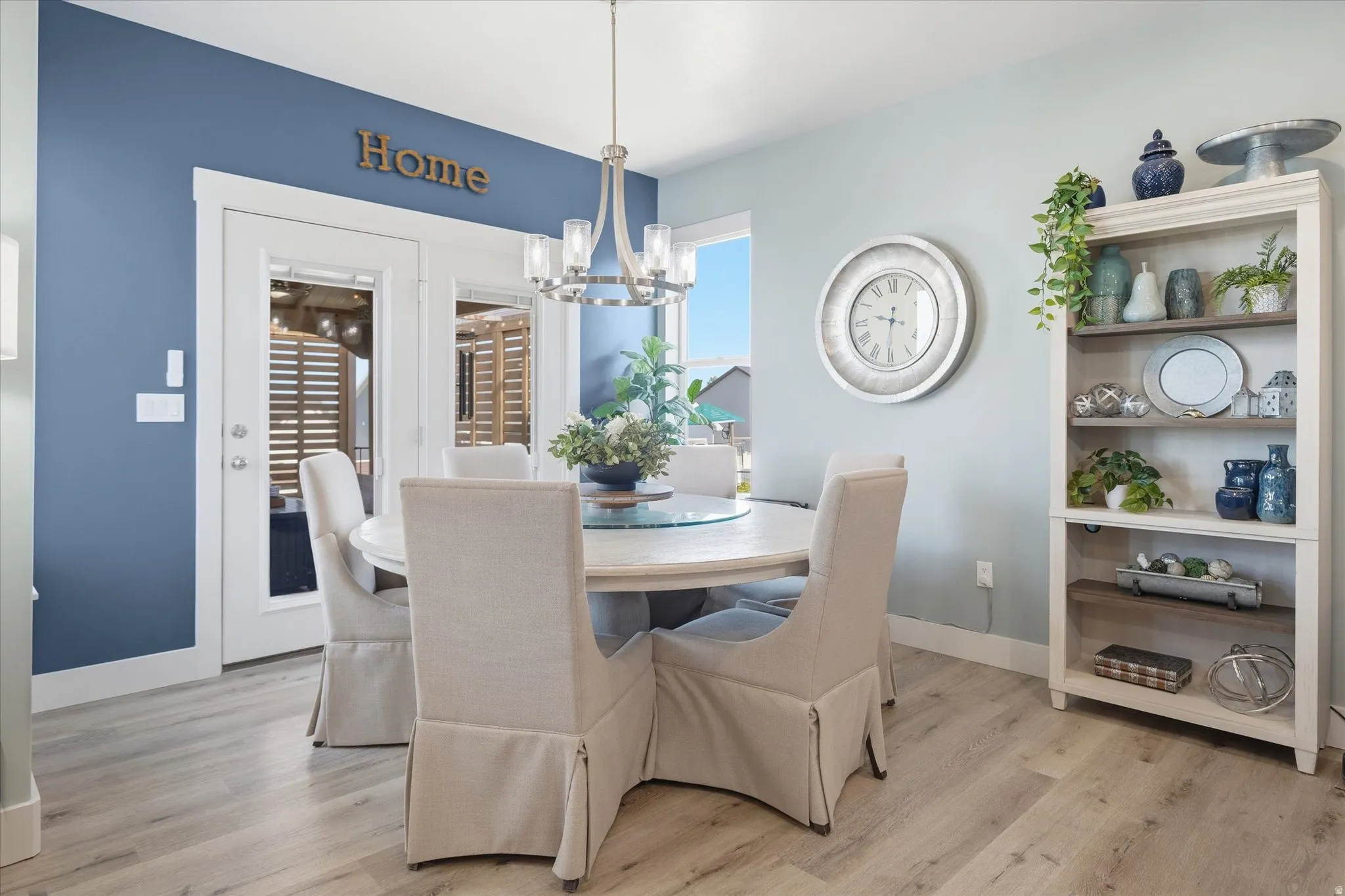 Dining area featuring wood-finish flooring and a contemporary chandelier