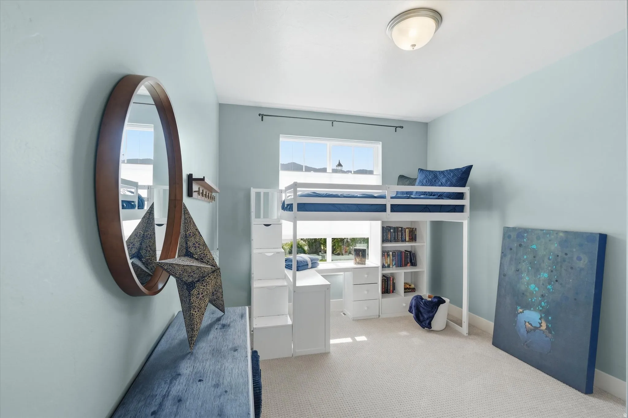 Recessed window with white blinds, light blue painted walls, and light-colored carpeting