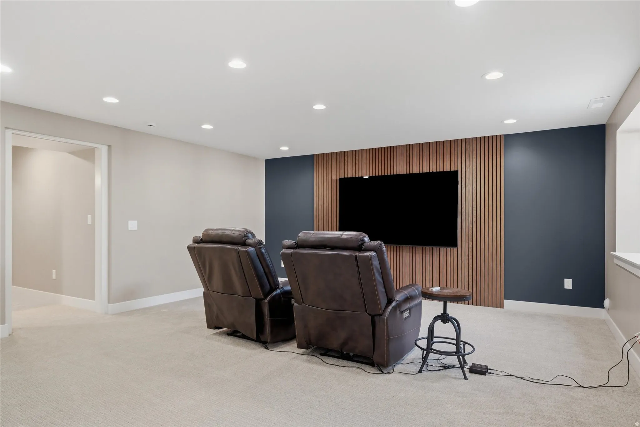 Accent wall featuring vertical wood paneling and a contrasting dark wall color