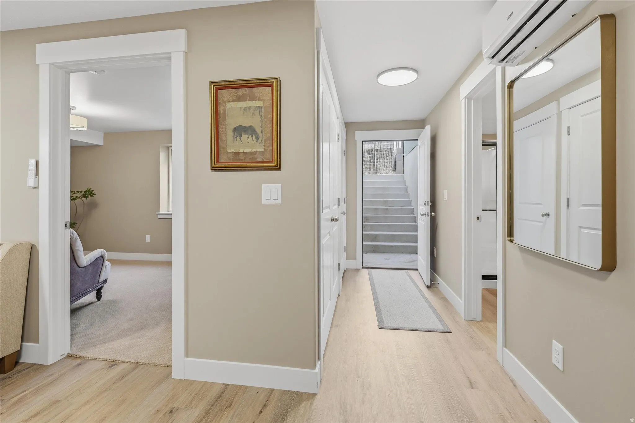 Apartment - Entrance & Hallway featuring light wood-finish flooring, white baseboards, and neutral wall tones