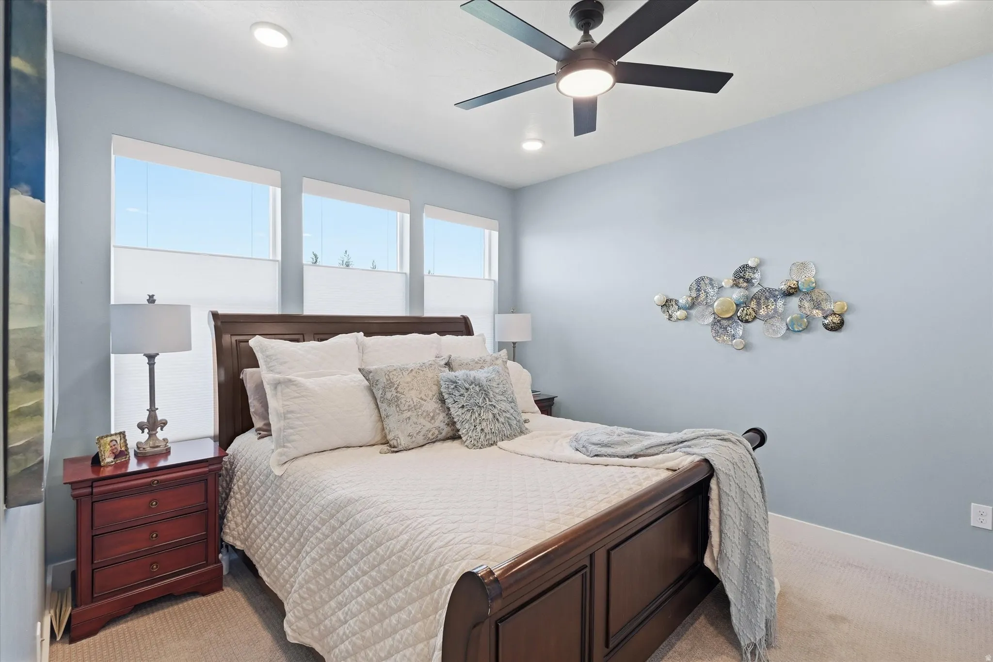 Bedroom featuring a dark wood bed frame and carpet flooring