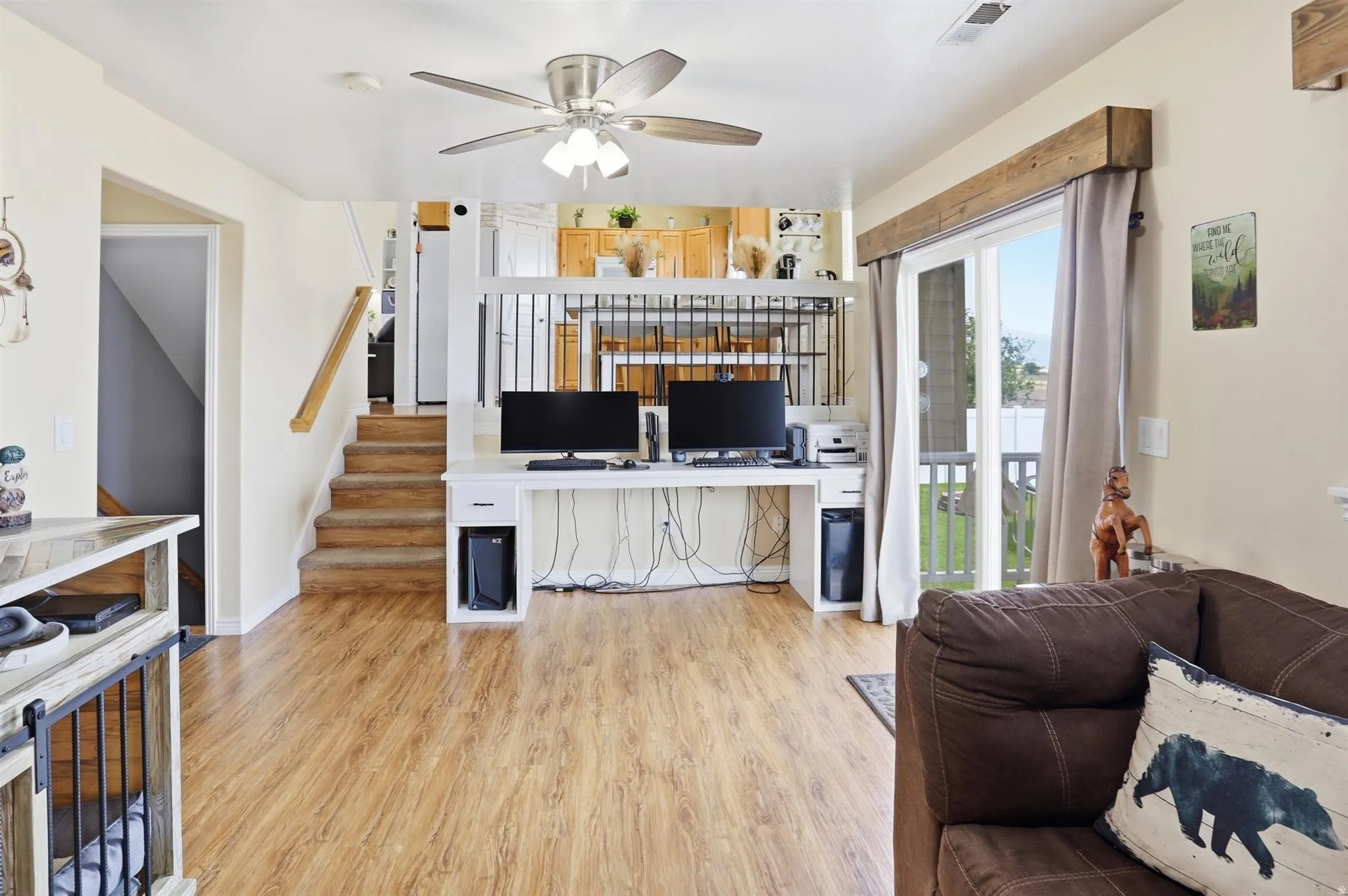 Living space featuring wood-finish flooring and a ceiling fan