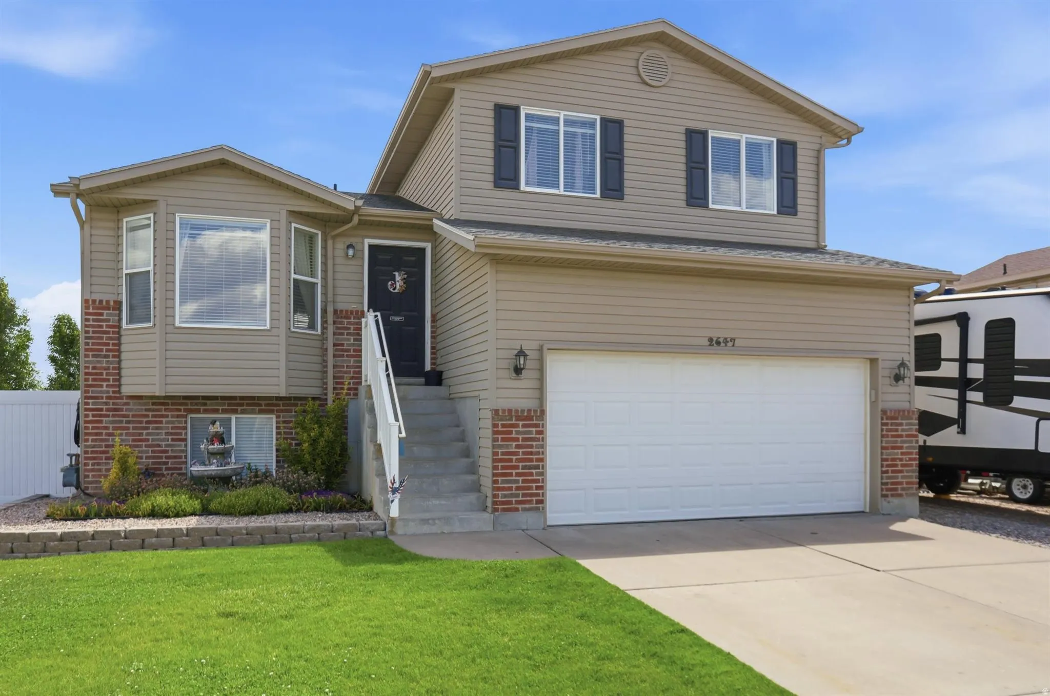 Two-story residence featuring a two-car garage with a concrete driveway