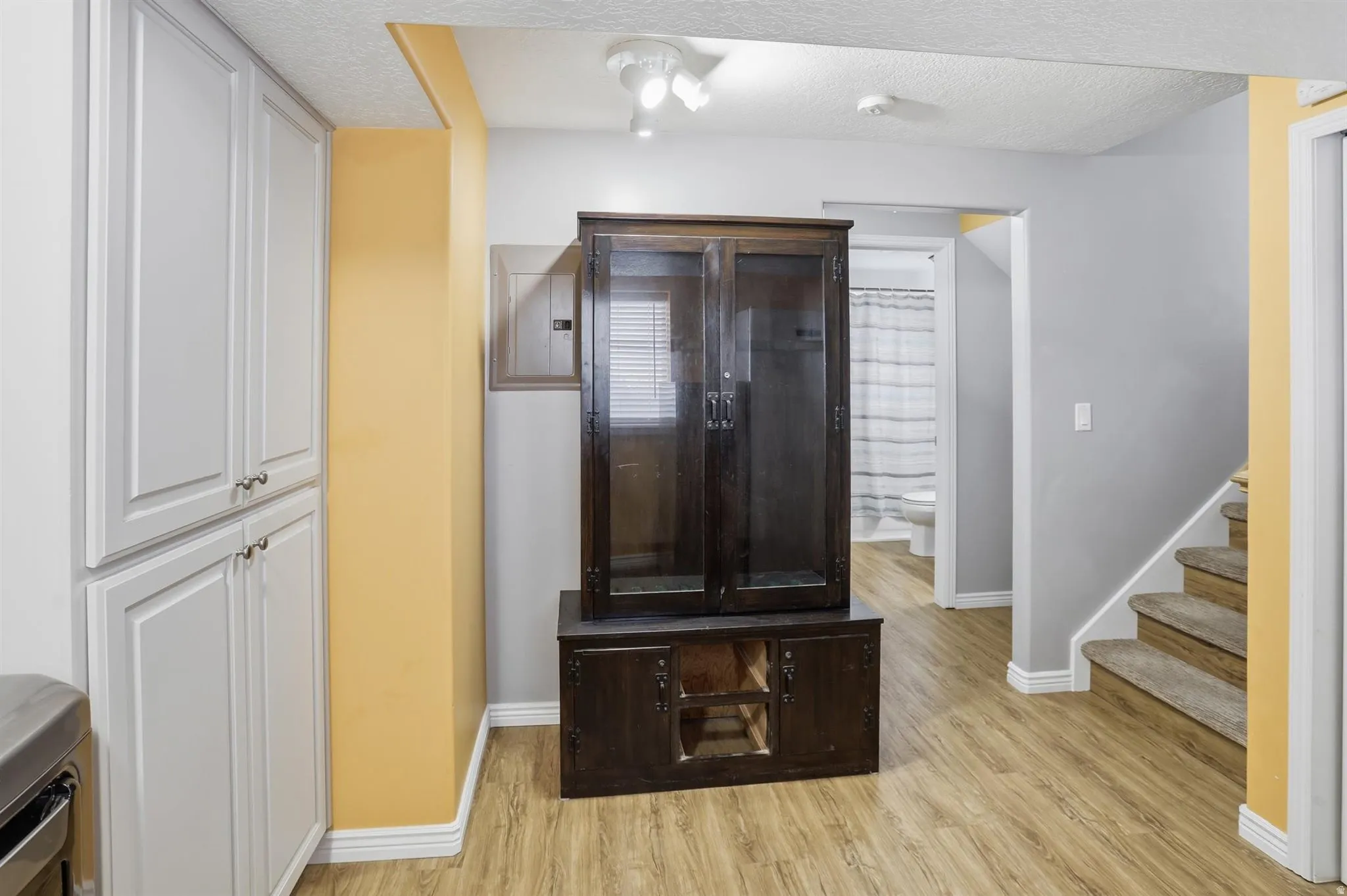 Light wood-finish flooring extending through the space
