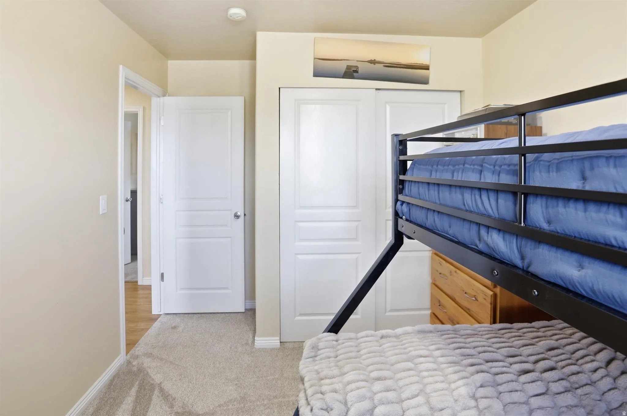 Bedroom #3 Neutral-toned room featuring anew light beige carpet and white trim
