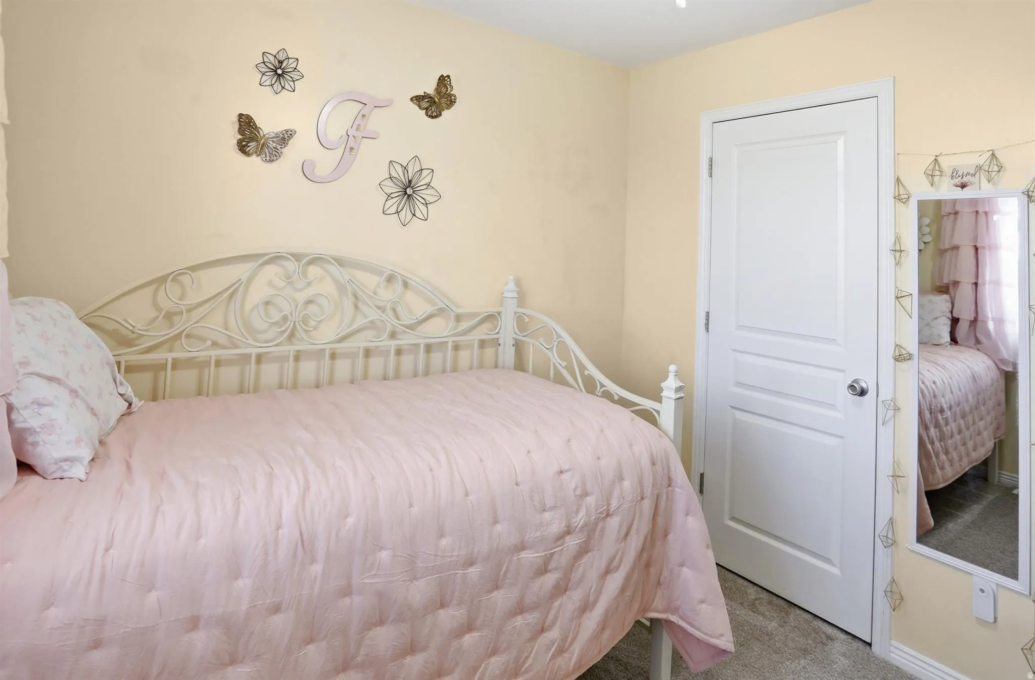 Interior room featuring soft yellow wall paint and grey carpet flooring