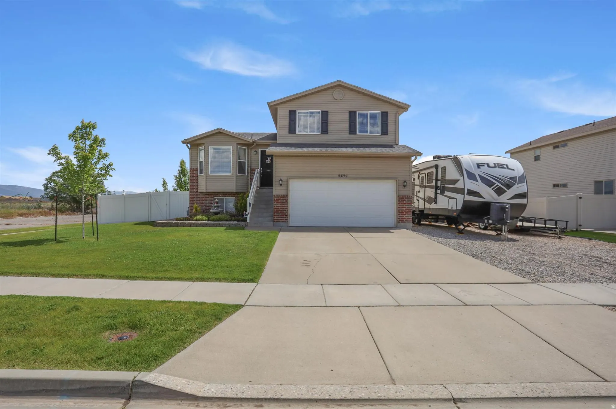 Front view of the home and the gravel RV pad