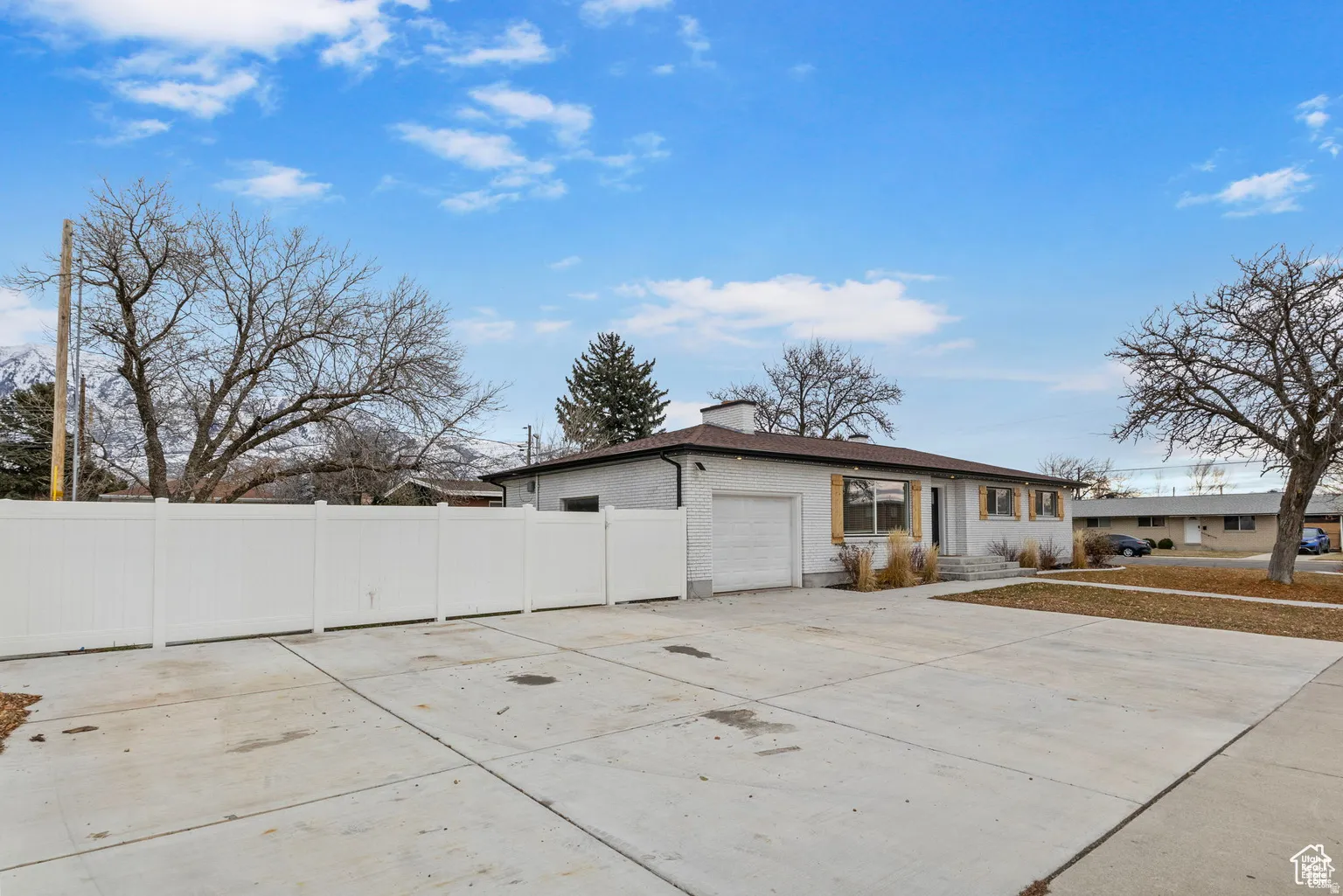 White brick exterior with a brown roof and matching trim