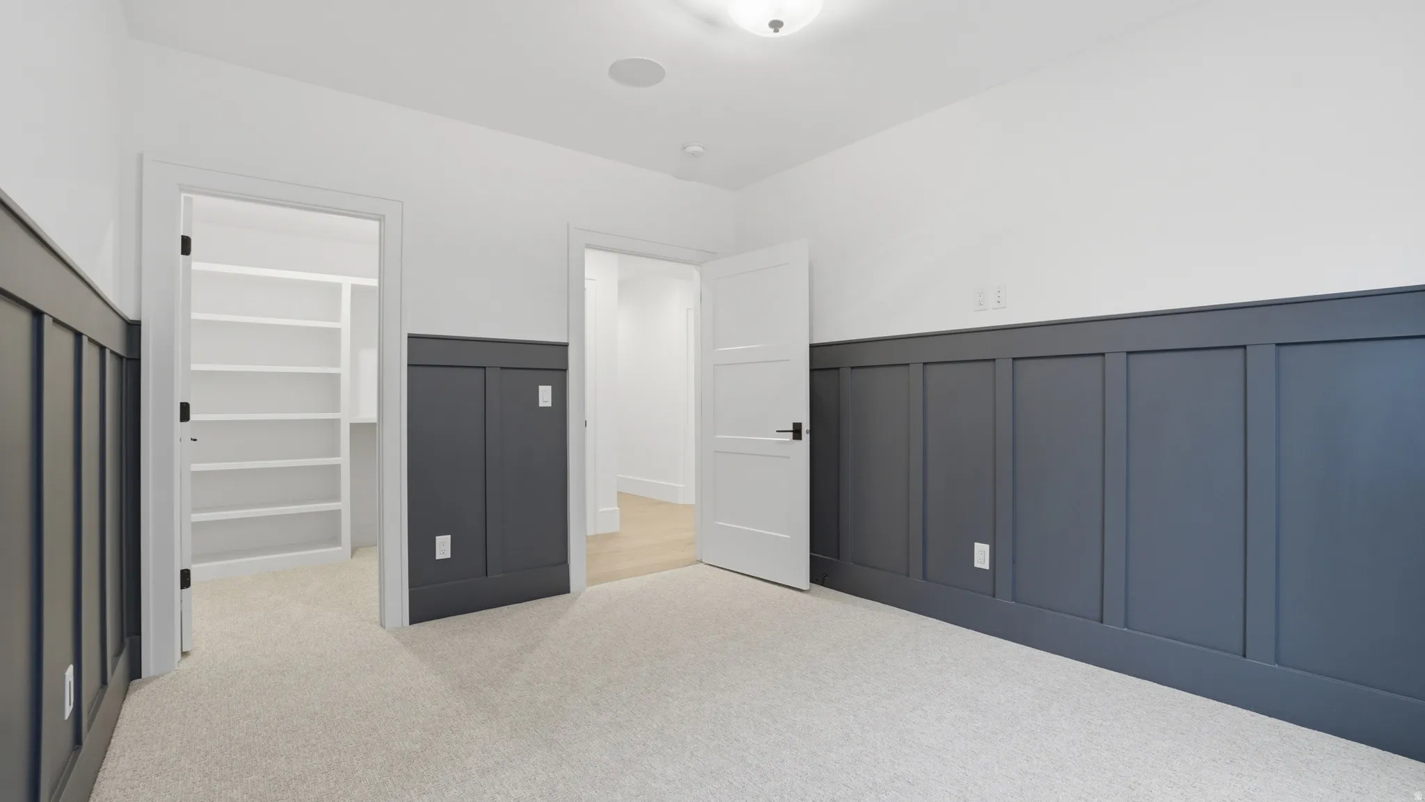 Room featuring two-tone walls with lower board and batten paneling