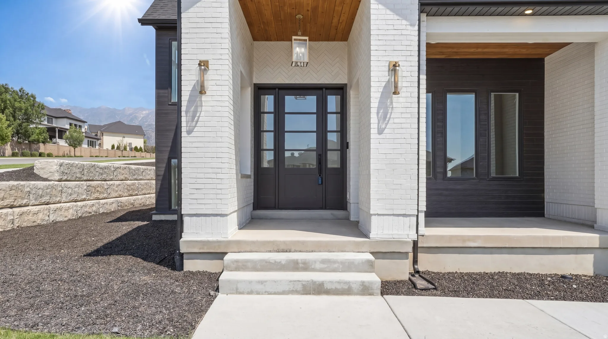 Modern facade featuring white brick and dark horizontal siding