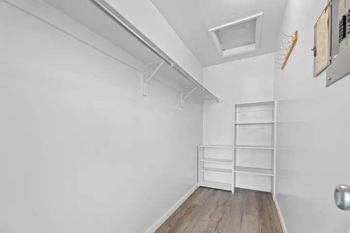 Walk-in closet featuring vinyl wood-finish flooring,  and white walls
