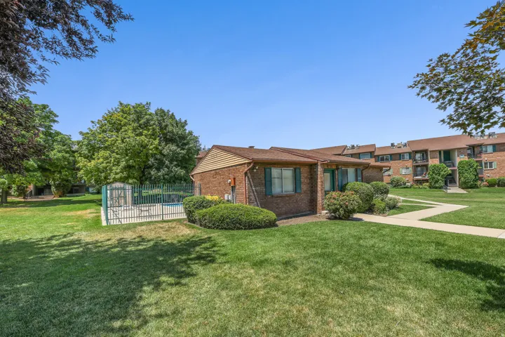 Expansive lawn area featuring a fenced pool, and mature trees