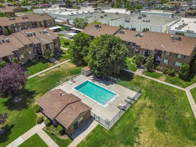 Community amenities featuring a fenced outdoor swimming pool with surrounding patio space and a dedicated pool house