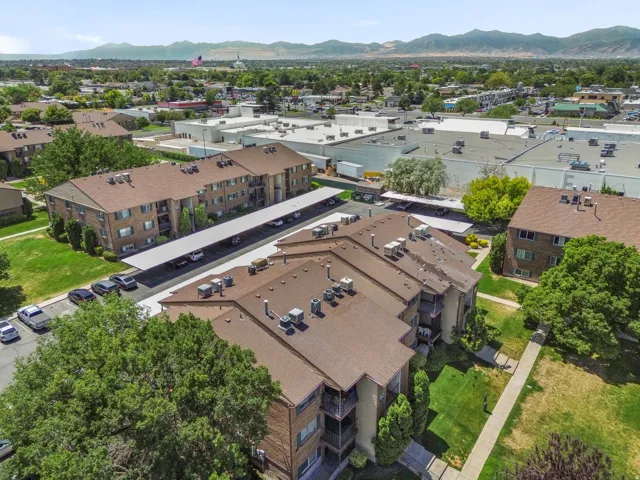 Multi-story residential buildings featuring brick and siding exteriors, balconies, and brown shingle roofs