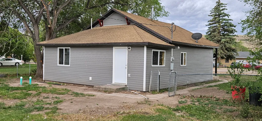 Gray horizontal siding with white trim and a brown asphalt shingle roof