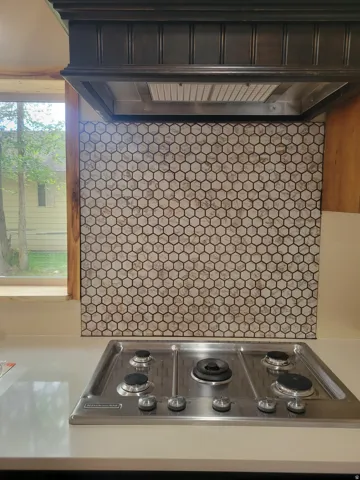Modern cooktop with stainless steel finish, integrated into a light-toned countertop
