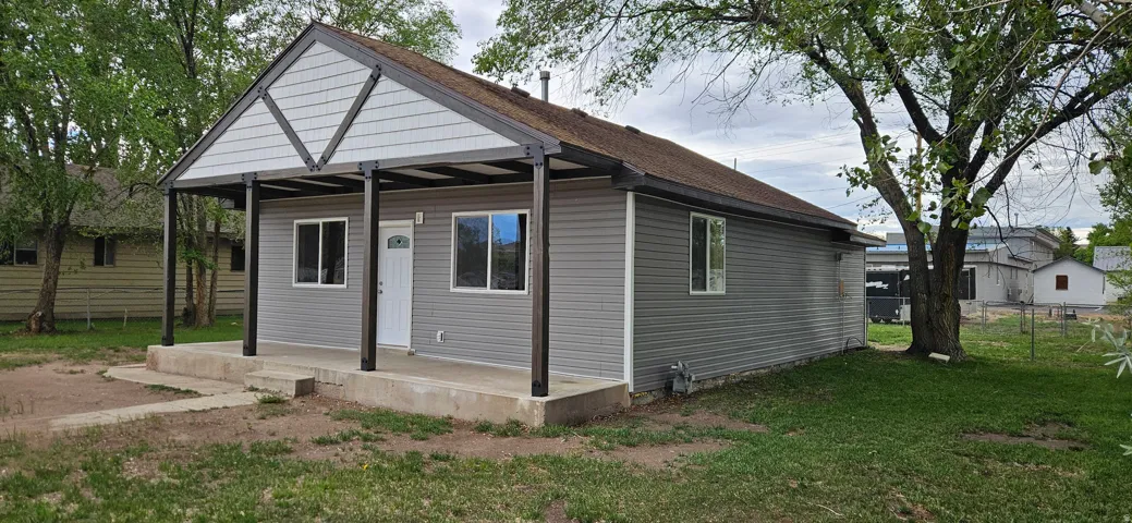 Single-story residence featuring gray horizontal siding and a covered front porch