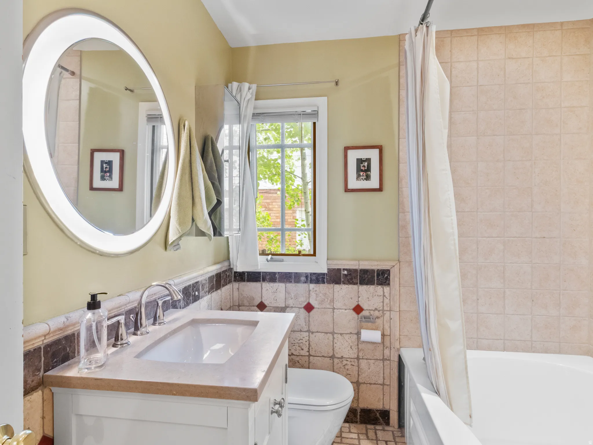 Bathroom featuring a vanity with an integrated sink and polished chrome faucet
