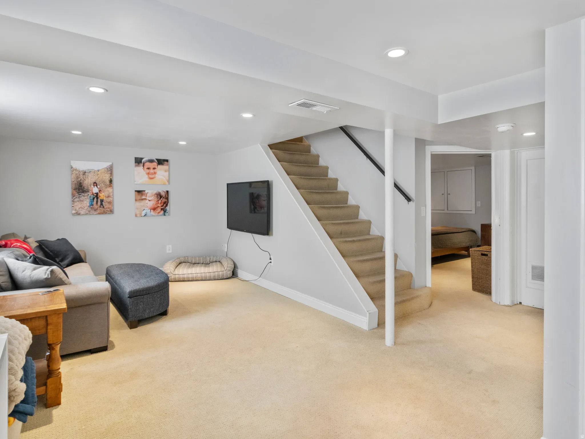 Carpeted recreation room featuring recessed lighting and a wall-mounted television