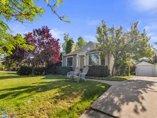 Gray-sided bungalow with a light green front door