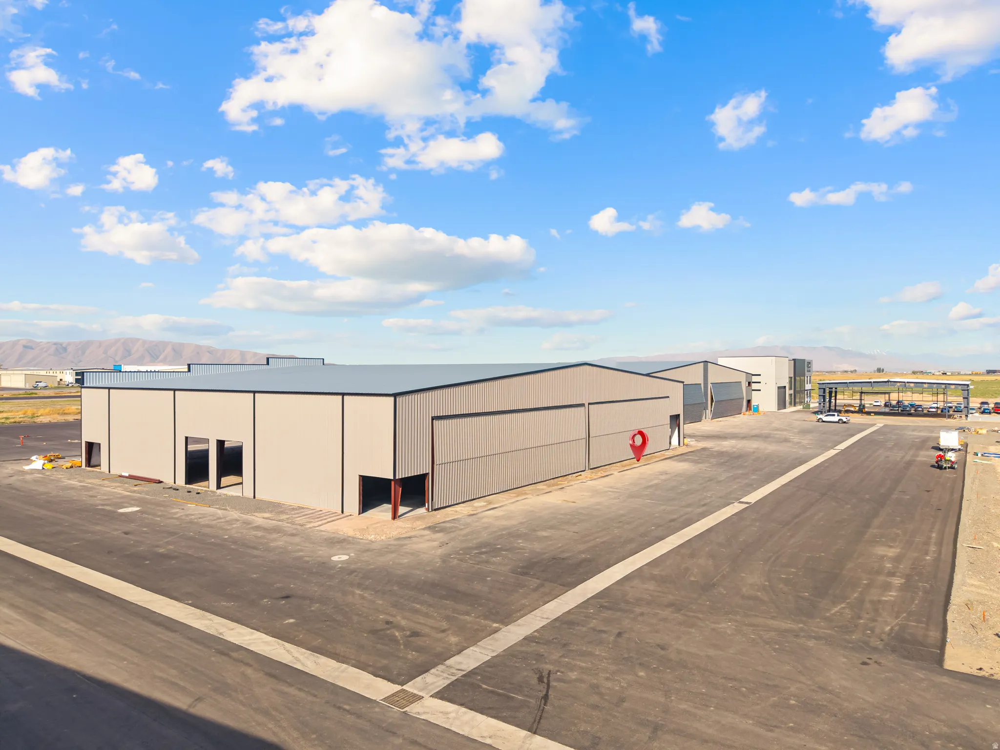 Industrial metal buildings with gray siding and dark trim