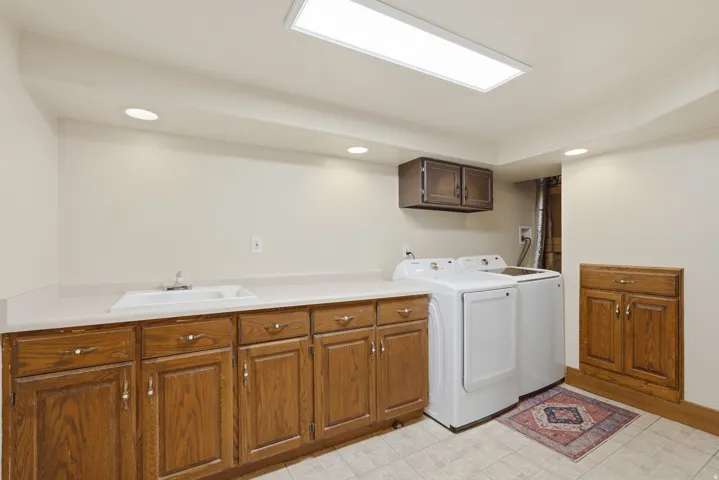 Oversized Laundry Room  with extra storage space and lots of cabinets