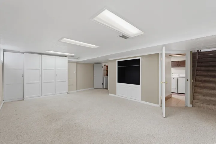 Spacious room featuring ample built-in cabinetry, and recessed ceiling lighting