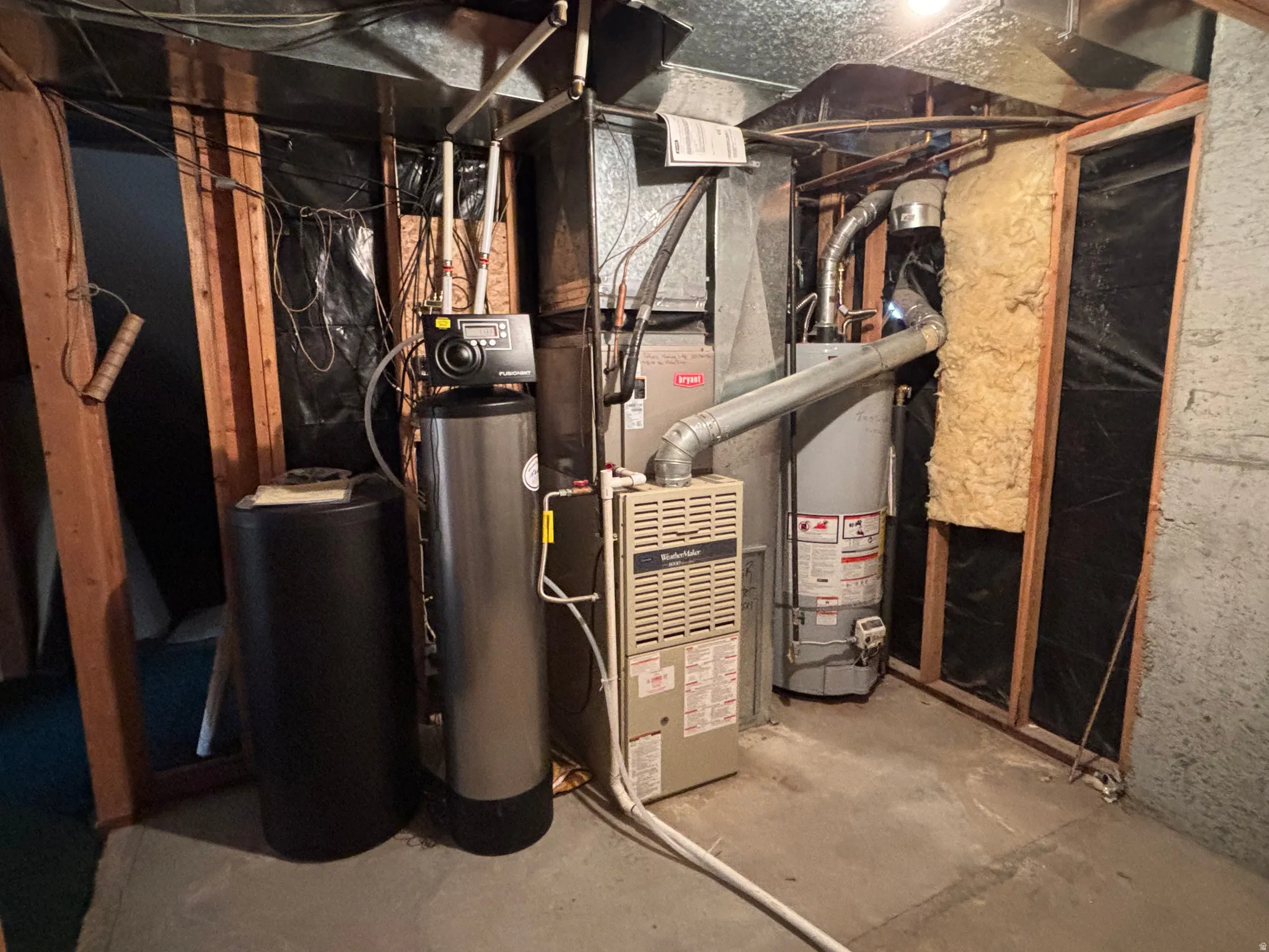 Mechanical room featuring a water heater, furnace, and water softener system