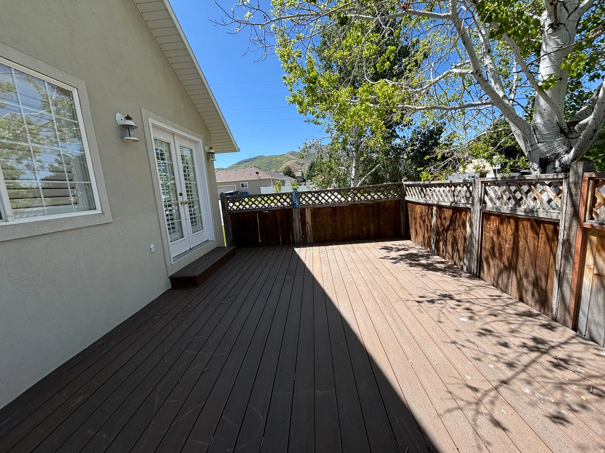 Spacious outdoor deck featuring wood-finish composite decking
