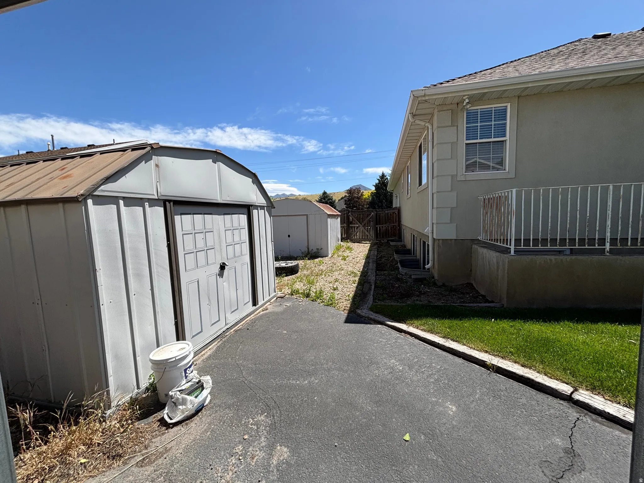 Exterior storage shed featuring a metal roof and double doors