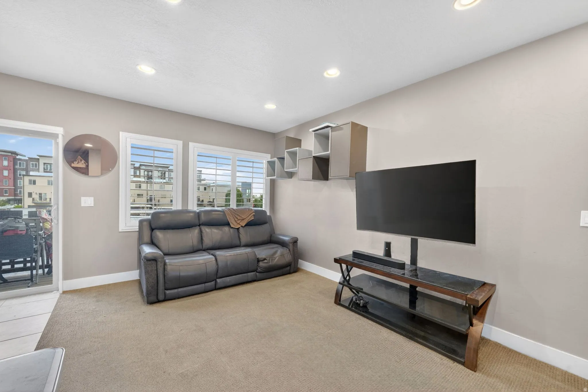 Living area featuring recessed lighting, neutral wall paint, and carpet flooring