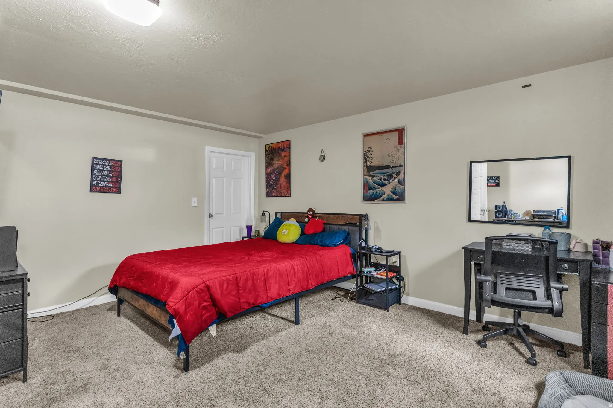 Carpeted room featuring a ceiling-mounted light fixture and light-toned walls