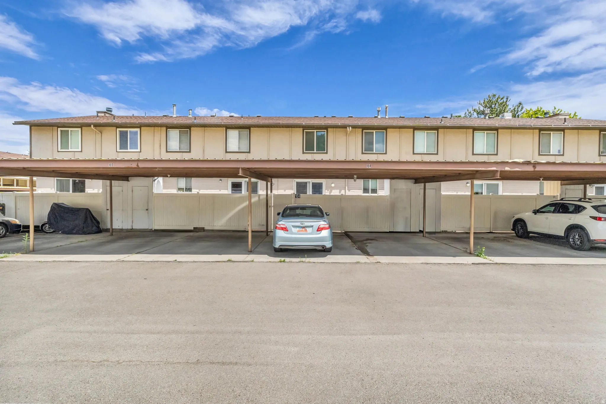 Covered parking structure with individual carport spaces